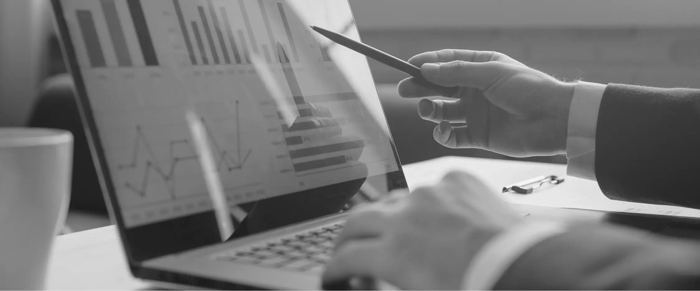 Charts and tables on a laptop during a discussion about data